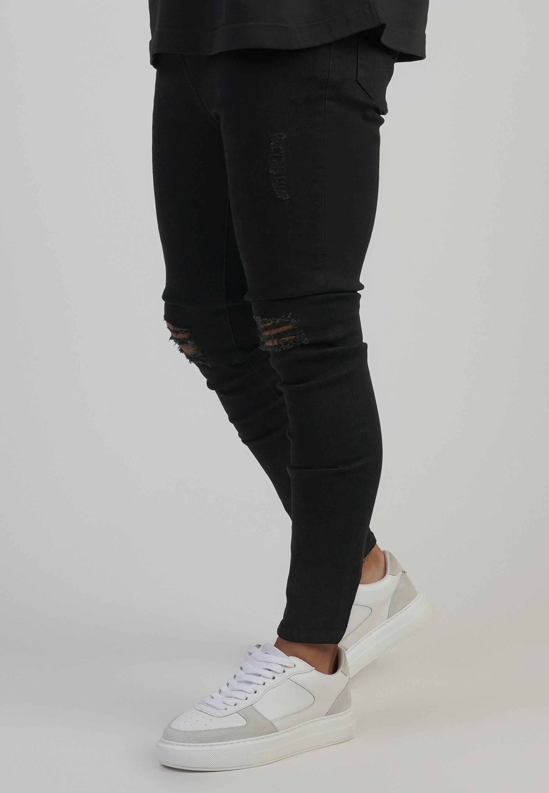 Distressed Skinny Jeans in Black Jeans SikSilk